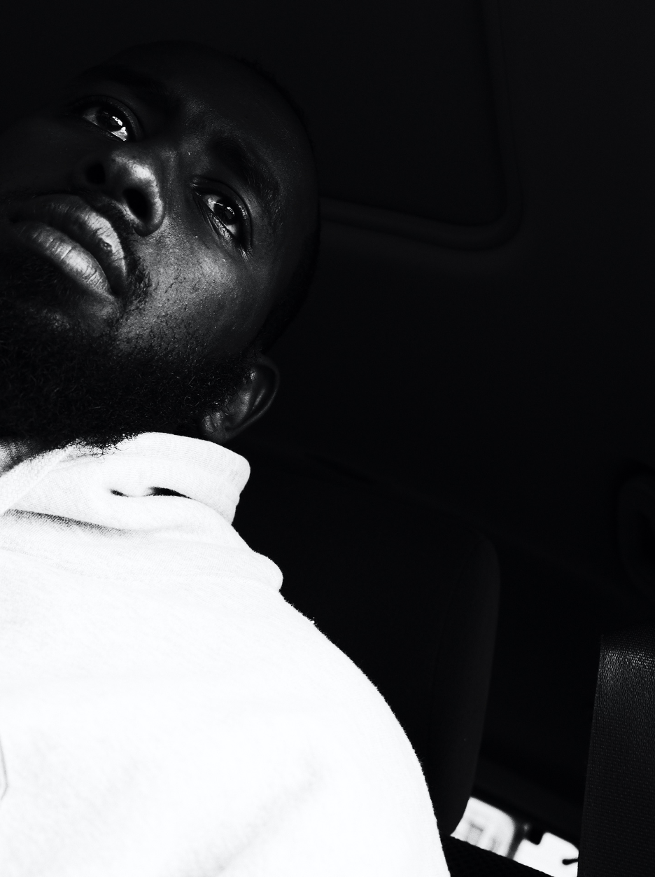 oblique self-portrait of author's face and shoulders, black and white photo