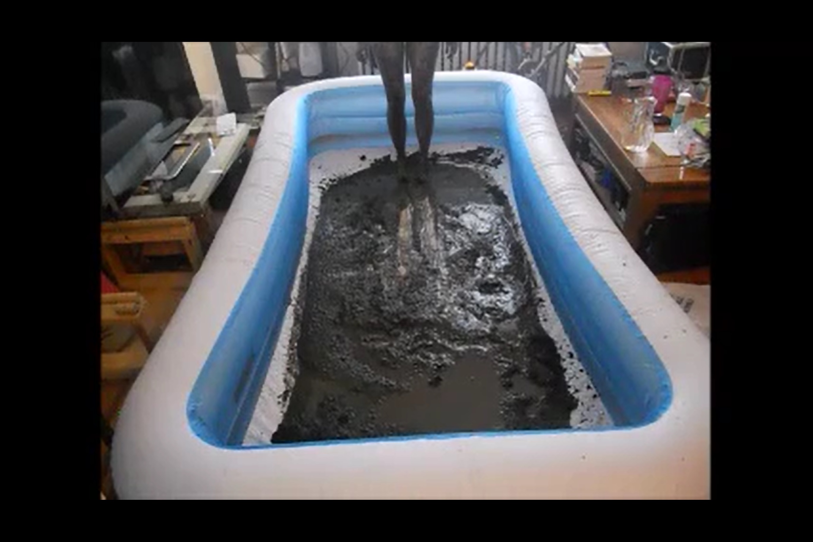 photo of author's muddy legs as is standing up in kiddie pool