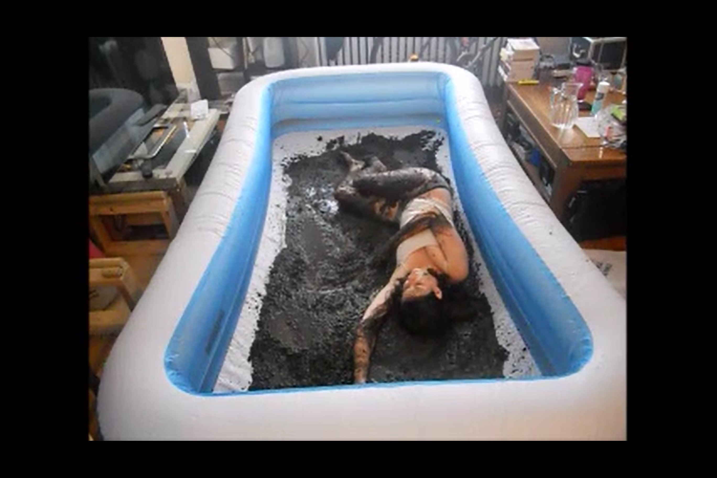 photo of author asleep in muddy kiddie pool